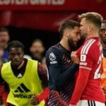 Tottenham's Rodrigo Bentancur, left, clashes with Manchester United's Luke Shaw during the English Premier League soccer match between Manchester United and Tottenham Hotspur.