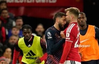 Tottenham's Rodrigo Bentancur, left, clashes with Manchester United's Luke Shaw during the English Premier League soccer match between Manchester United and Tottenham Hotspur.