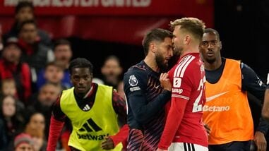 Tottenham's Rodrigo Bentancur, left, clashes with Manchester United's Luke Shaw during the English Premier League soccer match between Manchester United and Tottenham Hotspur.