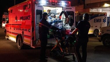 Paramedics load an injured person into an ambulance at the Wainwright Health Centre as injured military members are treated after a fire at Canadian Forces Base Wainwright, outside of Wainwright, Alberta Saturday, Oct. 17, 2026. (John Ulan/The Canadian Press via AP)