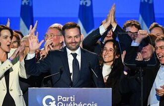 Parti Quebecois Leader Paul St-Pierre Plamondon, center, speaks to supporters after winning the provincial election in Montreal, Quebec on Monday, Oct. 5, 2026. (Graham Hughes/The Canadian Press via AP)