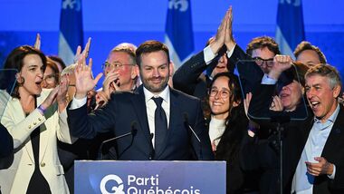 Parti Quebecois Leader Paul St-Pierre Plamondon, center, speaks to supporters after winning the provincial election in Montreal, Quebec on Monday, Oct. 5, 2026. (Graham Hughes/The Canadian Press via AP)
