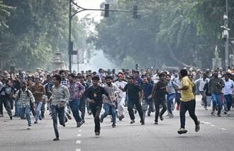 Protesters are seen running to evade detention by Delhi Police at Connaught Place on Saturday, October 10, 2026.