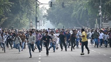 Protesters are seen running to evade detention by Delhi Police at Connaught Place on Saturday, October 10, 2026.