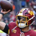 Washington Commanders quarterback Marcus Mariota (8) passes the ball as he warms-up before an NFL football game against Indianapolis Colts in London.