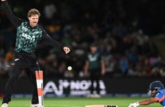New Zealand's Lockie Ferguson (L) reacts as India's Nitish Kumar Reddy successfully makes a run during the second T20I in Christchurch on Saturday.