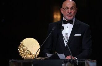 Spain head coach Luis de La Fuente speaks on stage after winning the Trophy for the Men's Coach of the Year during the 2026 Ballon d'Or France Football award ceremony in London on Monday.