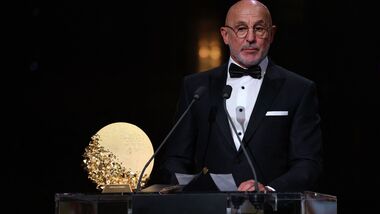 Spain head coach Luis de La Fuente speaks on stage after winning the Trophy for the Men's Coach of the Year during the 2026 Ballon d'Or France Football award ceremony in London on Monday.