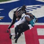 Philadelphia Eagles linebacker Jeremiah Trotter Jr. (54) and Jacksonville Jaguars wide receiver Brian Thomas Jr. (57) fight during the opening kick off at Tottenham Hotspur Stadium. Both players were ejected from the game.