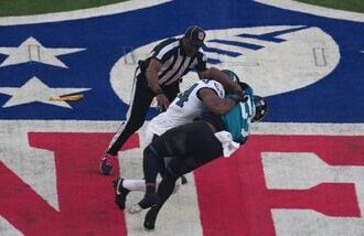 Philadelphia Eagles linebacker Jeremiah Trotter Jr. (54) and Jacksonville Jaguars wide receiver Brian Thomas Jr. (57) fight during the opening kick off at Tottenham Hotspur Stadium. Both players were ejected from the game.