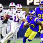 Buffalo Bills quarterback Josh Allen (17) scrambles as Los Angeles Rams linebacker Nate Landman (53) defends during overtime at SoFi Stadium.