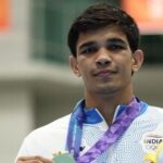 Gold medallist India's Ankush celebrates on the podium after winning the Men's 80kg boxing competition in the 2026 Asian Games in Nagoya.
