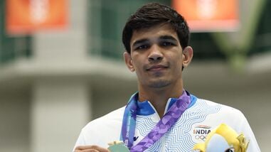 Gold medallist India's Ankush celebrates on the podium after winning the Men's 80kg boxing competition in the 2026 Asian Games in Nagoya.