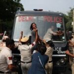 CJP Protest at Jantar Mantar: A protester reacts as she tries to stop the police bus carrying detained protesters during a protest organised by the Cockroach Janta Party (CJP), seeking the resignation of India's Chief Election Commissioner, Gyanesh Kumar, in New Delhi, India, October 10, 2026.