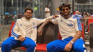 India's Kuldeep Yadav (L) and Tilak Varma on their way to New Zealand.