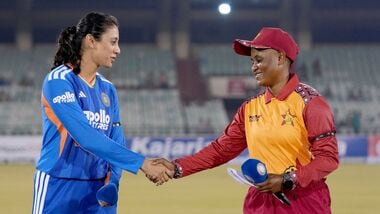 Indian captain Smriti Mandhana (L) and her Zimbabwean counterpart Josephine Nkomo.