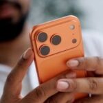 A customer holds an iPhone 17 Pro smartphone.