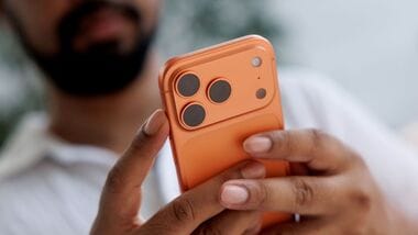 A customer holds an iPhone 17 Pro smartphone.