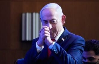 Israeli Prime Minister Benjamin Netanyahu greets his supporters at Likud party headquarters in Jerusalem after the release of the first exit poll results in Israel's general election, Wednesday, Oct. 28, 2026.