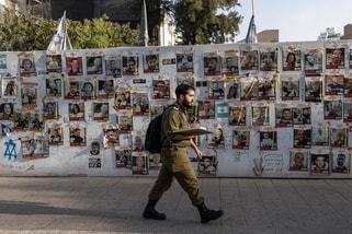 An Israeli soldier walks past pictures of hostages kidnapped during the deadly October 7 attack by the Palestinian Islamist group Hamas, at Dizengoff Square in Tel Aviv, Israel, May 22, 2024. REUTERS/Marko Djurica