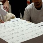 Workers prepare freshly printed ballot papers at a printing plant ahead of the Israeli legislative elections in Kiryat Gat, southern Israel, on October 8, 2026. (Photo by JACK GUEZ / AFP)