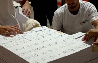 Workers prepare freshly printed ballot papers at a printing plant ahead of the Israeli legislative elections in Kiryat Gat, southern Israel, on October 8, 2026. (Photo by JACK GUEZ / AFP)