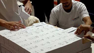 Workers prepare freshly printed ballot papers at a printing plant ahead of the Israeli legislative elections in Kiryat Gat, southern Israel, on October 8, 2026. (Photo by JACK GUEZ / AFP)