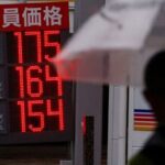 FILE PHOTO: Signboards display fuel prices outside gasoline stations in Tokyo, Japan