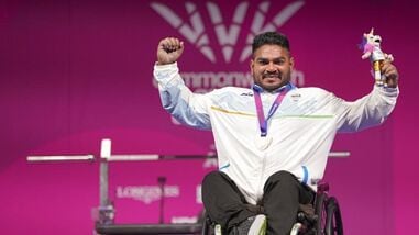 India's Jhandu Kumar celebrates after winning the bronze medal during the medal ceremony for the men's heavyweight para powerlifting event at the Commonwealth Games 2026, in Glasgow, Friday (PTI)