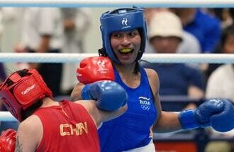 India's Lovlina Borgohain, in blue, and China's Bao Ziyi, in red, fight in their women's 75kg boxing final match at the Asian Games in Nishio, Aichi prefecture, Japan, Friday.