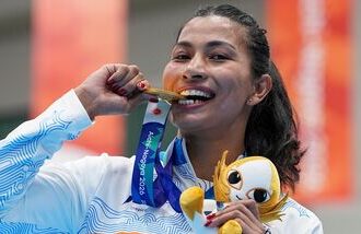 Gold medallist India's Lovlina Borgohain poses for photographers during the medal ceremony for the women's 75kg boxing event at the 20th Asian Games 2026.