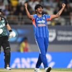 India bowler Mayank Yadav celebrates the wicket of New Zealand's Daryl Mitchell, left, during the T20 cricket international between New Zealand and India in Auckland, New Zealand, Friday, Oct. 30, 2026. (Andrew Cornaga/Photosport via AP)