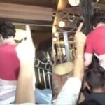 Priyanka Gandhi climbs a gate after being detained