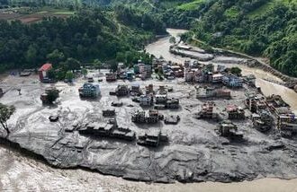 A drone view shows mud covering buildings and property following devastating floods at Trishuli in Nuwakot district, Nepal, August 27, 2026. REUTERS/Navesh Chitrakar