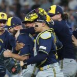 Aaron Ashby #26 of the Milwaukee Brewers celebrates with teammates after recording the final out of the game against the Los Angeles Dodgers in game four of the National League Championship Series at Dodger Stadium.