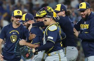 Aaron Ashby #26 of the Milwaukee Brewers celebrates with teammates after recording the final out of the game against the Los Angeles Dodgers in game four of the National League Championship Series at Dodger Stadium.
