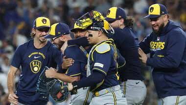 Aaron Ashby #26 of the Milwaukee Brewers celebrates with teammates after recording the final out of the game against the Los Angeles Dodgers in game four of the National League Championship Series at Dodger Stadium.