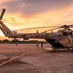 TOPSHOT - A general view of a Nigerian Air Force helicopter parked on the tarmac of the Maiduguri Air Force Baseb as the sun sets on August 2, 2026. Northeast Nigeria has been gripped by an Islamist extremist insurgency since 2009, first by Boko Haram, then its offshoot and rival, the Islamic State West Africa Province (ISWAP). The groups have since last year stepped up reported attacks on villages, police stations and workers such as loggers and fishermen, as well as military bases, killing several senior army officers. The upsurge in attacks prompted President Bola Tinubu to declare a nationwide state of emergency in 2025 (Photo by AFP)