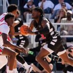 Jayden Hastings #22 of the Cincinnati Bearcats passes the ball while being guarded by Josh Ojianwuna #17 of the Ohio State Buckeyes in the first half of an exhibition game during the 2026 CareSource Invitational at the Lindner Family Tennis Center.
