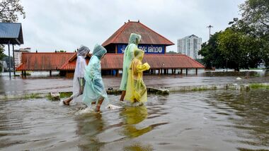 Kochi: Children cover themselves as they move on a waterlogged road following rainfall, near Sree Mahadeva Temple, in Kochi, Kerala, Saturday, Aug. 1, 2026. (PTI Photo)(PTI08_01_2026_000303A)