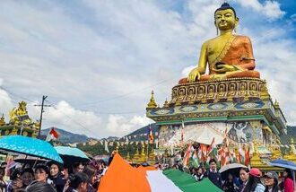 Tawang: Participants carry a 100-metre-long national tricolour near the Giant Buddha Statue during a 'Tiranga Yatra' organized as part of the 'Har Ghar Tiranga' campaign ahead of Independence Day celebrations, in Tawang, Arunachal Pradesh, Wednesday, Aug. 12, 2026. (PTI Photo)(PTI08_12_2026_000396B)
