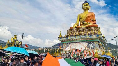 Tawang: Participants carry a 100-metre-long national tricolour near the Giant Buddha Statue during a 'Tiranga Yatra' organized as part of the 'Har Ghar Tiranga' campaign ahead of Independence Day celebrations, in Tawang, Arunachal Pradesh, Wednesday, Aug. 12, 2026. (PTI Photo)(PTI08_12_2026_000396B)
