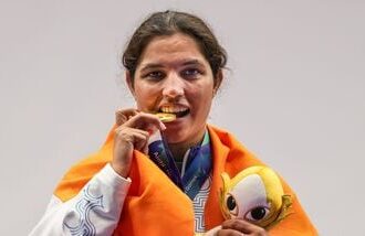 India's Neeru Dhanda poses with her gold medal and the event mascot during the victory ceremony for the women's trap shooting individual event at Asian Games 2026 in Nagoya.