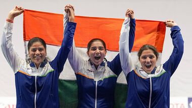 India's Manisha Keer (Left), Ashima Ahlawat (Centre) and Neeru Dhanda (Right) pose with the national flag after winning the silver medal during the victory ceremony for the women's trap shooting team event at Asian Games 2026 in Nagoya.