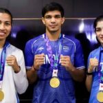 Asian Games 2026 gold medallist boxers, from left, Lovlina Borgohain, Ankush Panghal and Parveen Hooda pose for photographers upon their arrival at the Indira Gandhi International (IGI) Airport, in New Delhi on Sunday.