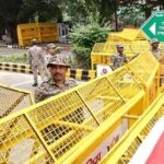 Police personnel stand near barricades ahead of a Tiranga March rally by CJP at Tolstoy Marg in New Delhi