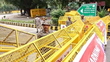Police personnel stand near barricades ahead of a Tiranga March rally by CJP at Tolstoy Marg in New Delhi