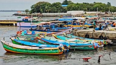 Fishing boats remain anchored at a fishing harbour following a cyclone alert, in Thoothukudi, Tamil Nadu