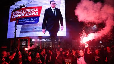 People celebrate after Aleksandar Vucic, leader of the right-wing Serbian Progressive Party (SNS) , seen on the top display, conceded defeat in the parliamentary election in Belgrade, Serbia, Sunday, Oct. 25, 2026. (AP Photo/Armin Durgut)
