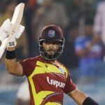 West Indies' skipper Shai Hope raises his bat as he celebrates his century in the 4th T20I against India at Rajiv Gandhi International Stadium, in Hyderabad.